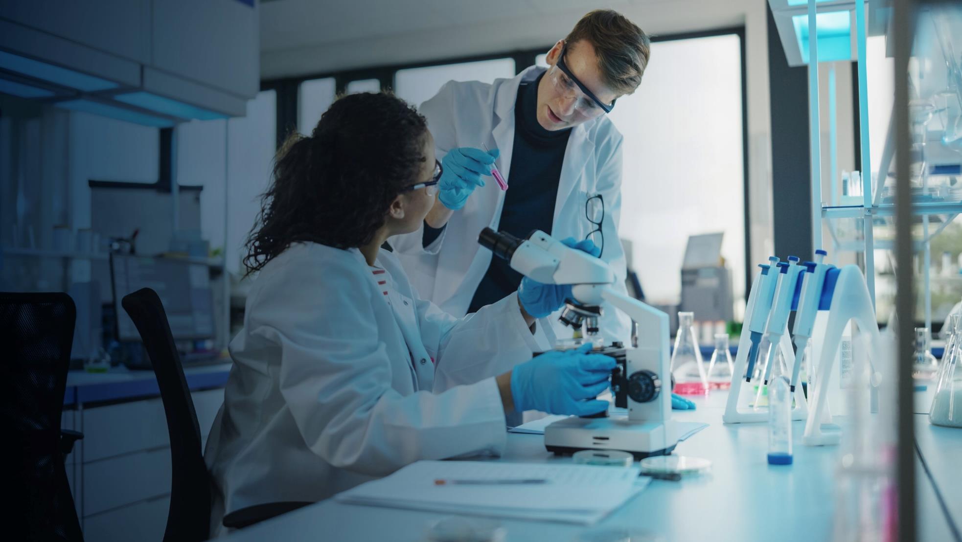 Two technicians working in the lab, using the STARLIMS R&D Quality Manufacturing Informatics Platform