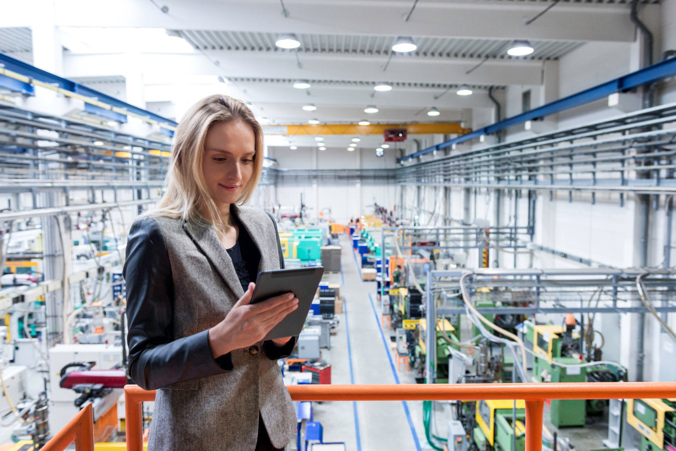 Woman looking at a tablet in a factory