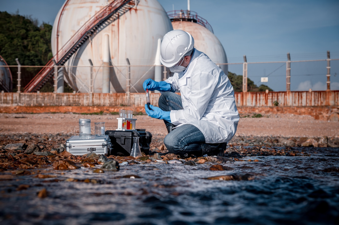 Scientist wearing safety uniform and glove under working water analysis and water quality by testing waste water.