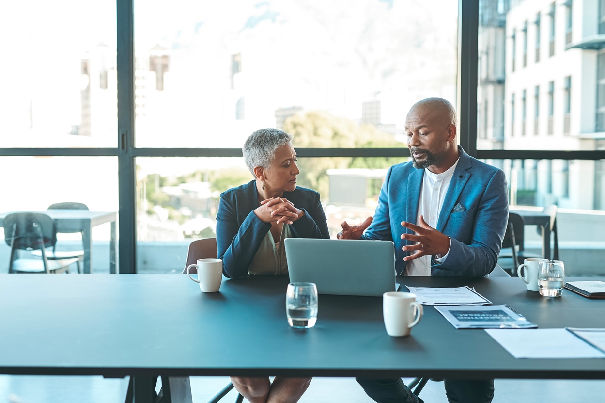 Business, presentation and man on a laptop in a corporate conference or office collaboration with a woman at work.